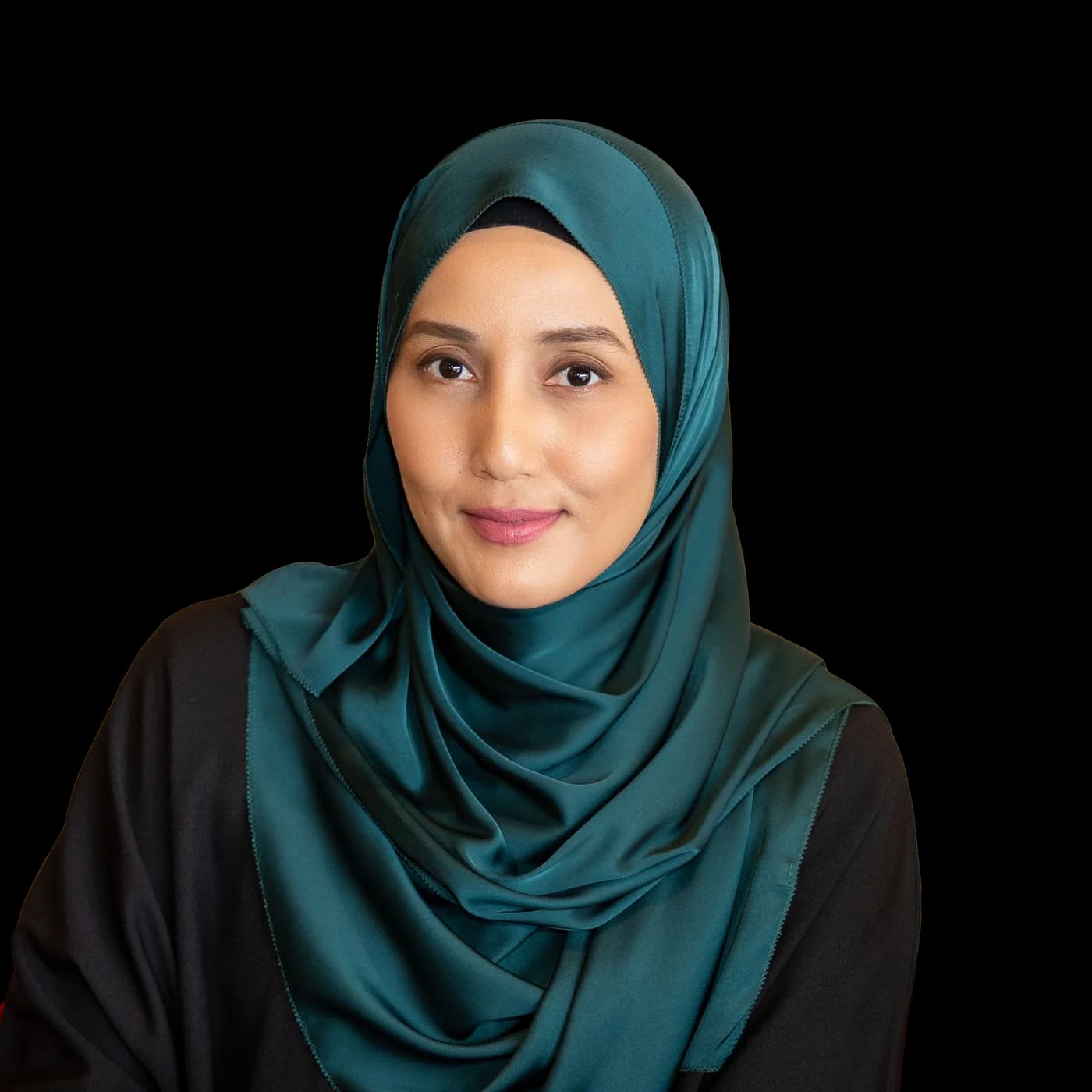 Portrait of Che Nom wearing a teal hijab